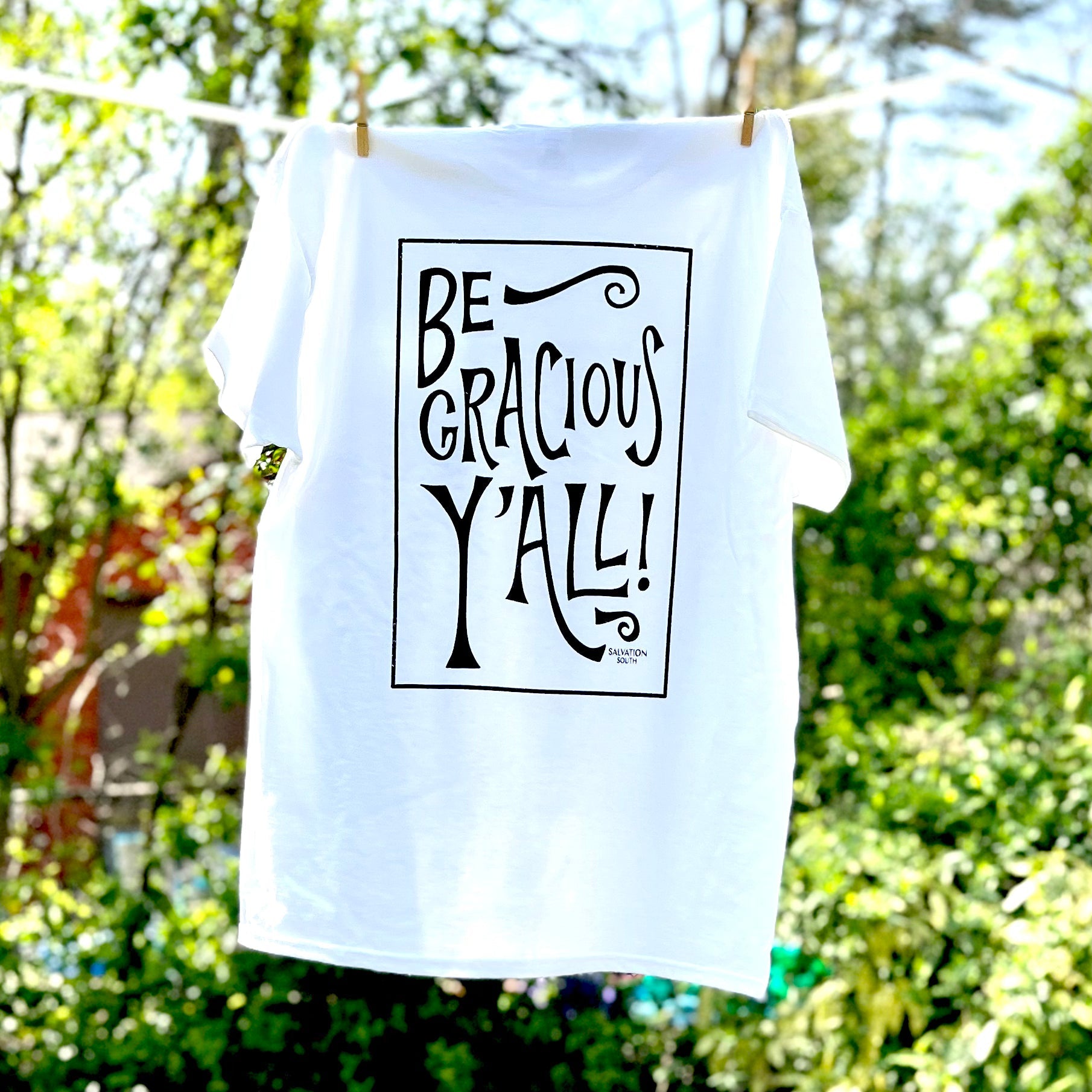 Salvation South - The Be Gracious Y'all T-shirt on a clothesline
